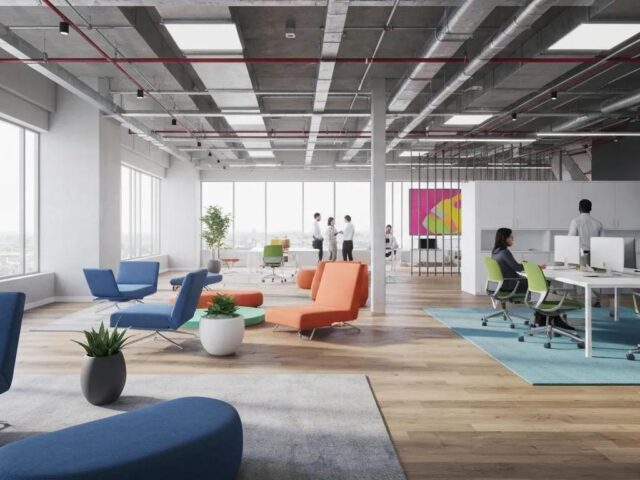 Modern office interior featuring colorful seating areas, collaborative workspace, and large windows, emphasizing cleanliness and professional environment for commercial cleaning services.